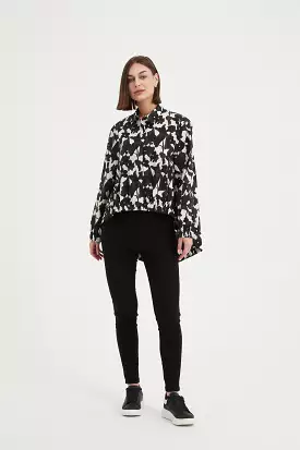 Tirelli black floral print shirt with elastic front hem.